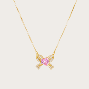 Elegant Nayla Bow Necklace in 18K gold-plated stainless steel with a zircon bow and pink heart.