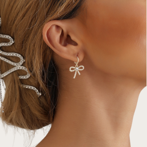 Model wearing Gold Bow Earrings with sparkling zircon stones, adding charm and shine to your look.