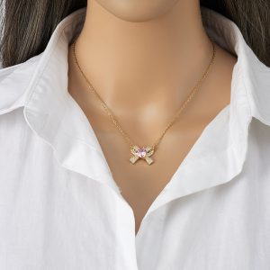 Elegant Nayla Bow Necklace in 18K gold-plated stainless steel with a zircon bow and pink heart.